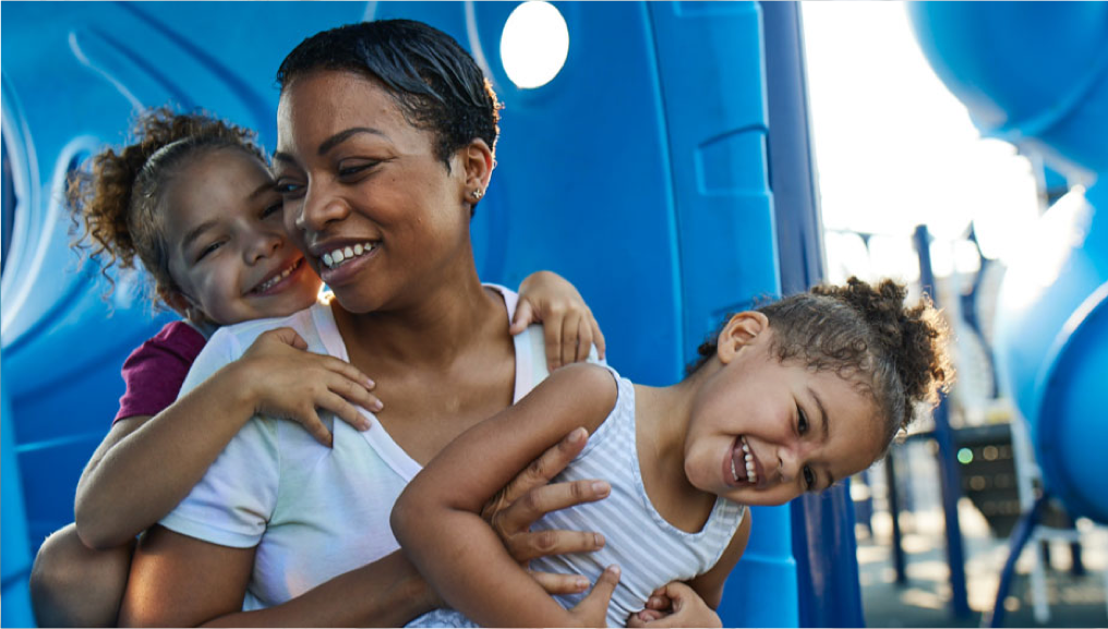 Mother playing with children at a BlueCross Healthy Place