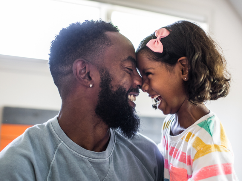 Father laughing with small child