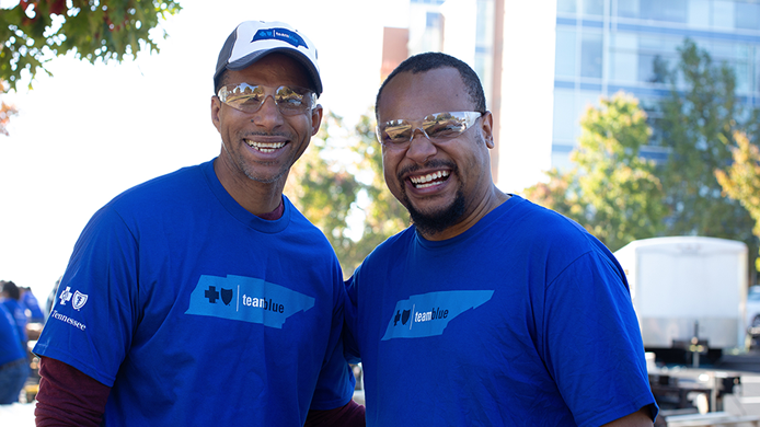 Two BlueCross employees volunteering and smiling