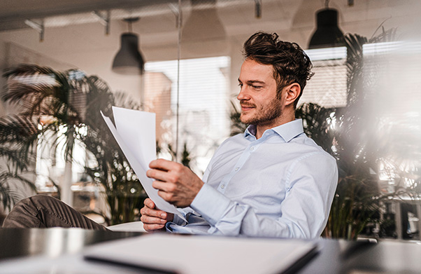 Man sitting at desk reading documents