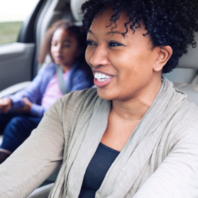 Woman driving and talking to young daughter