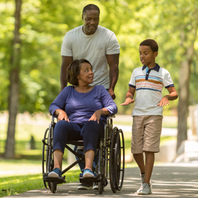 Father and son on walk with grandmother in wheelchair Father and son on walk with grandmother in wheelchair